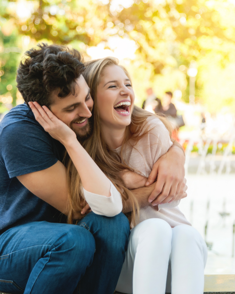 Image of a couple smiling, laughing, and embracing each other