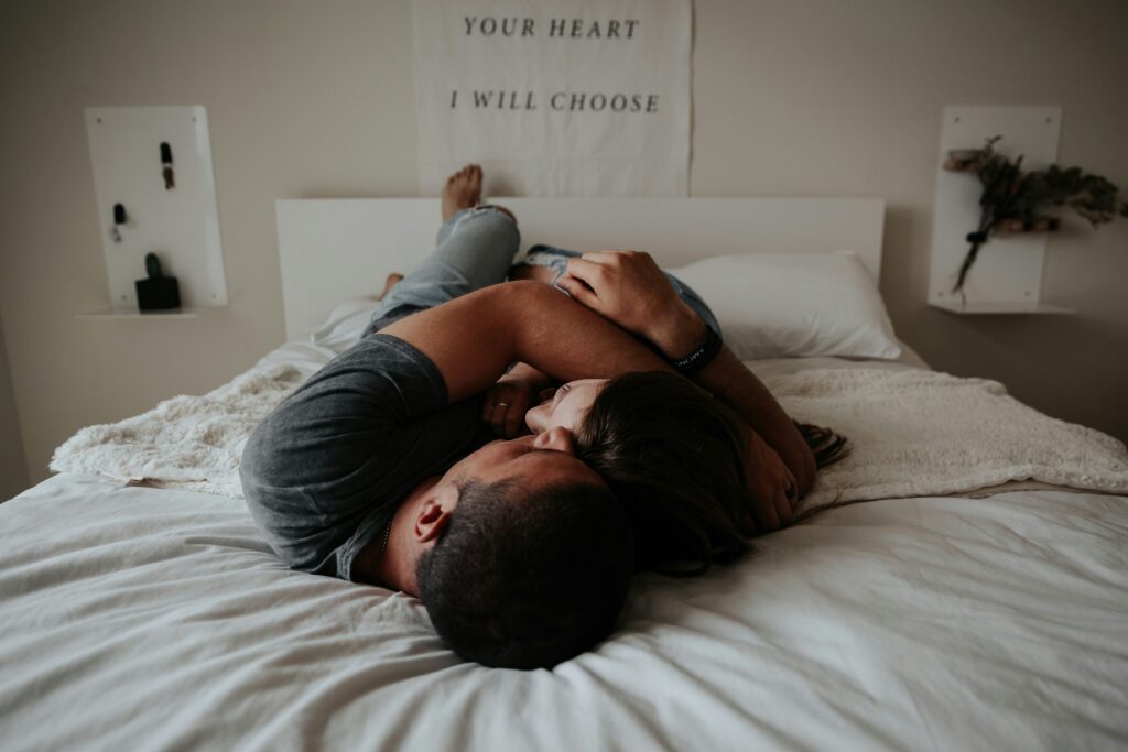 Image of a couple cuddling on a bed