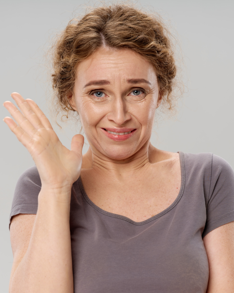 Image of a woman waving awkardly