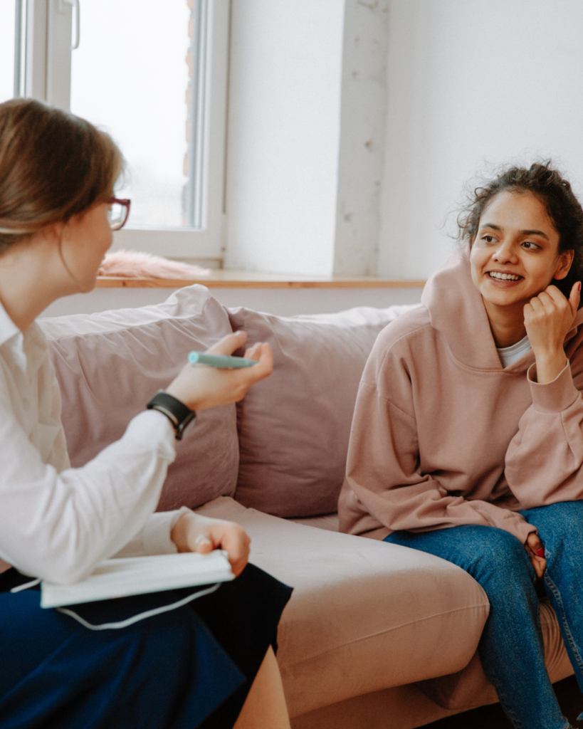 Image of a woman in an office talking to her therapist, who is gesturing with her hands.